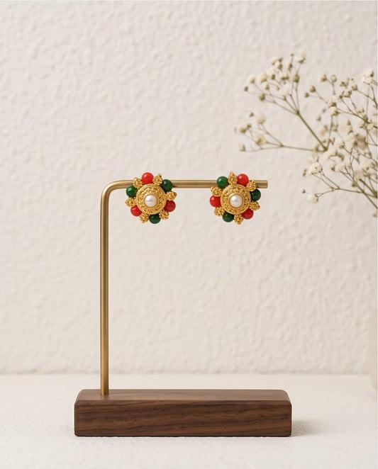 Decorative earrings on a wooden stand with a white background